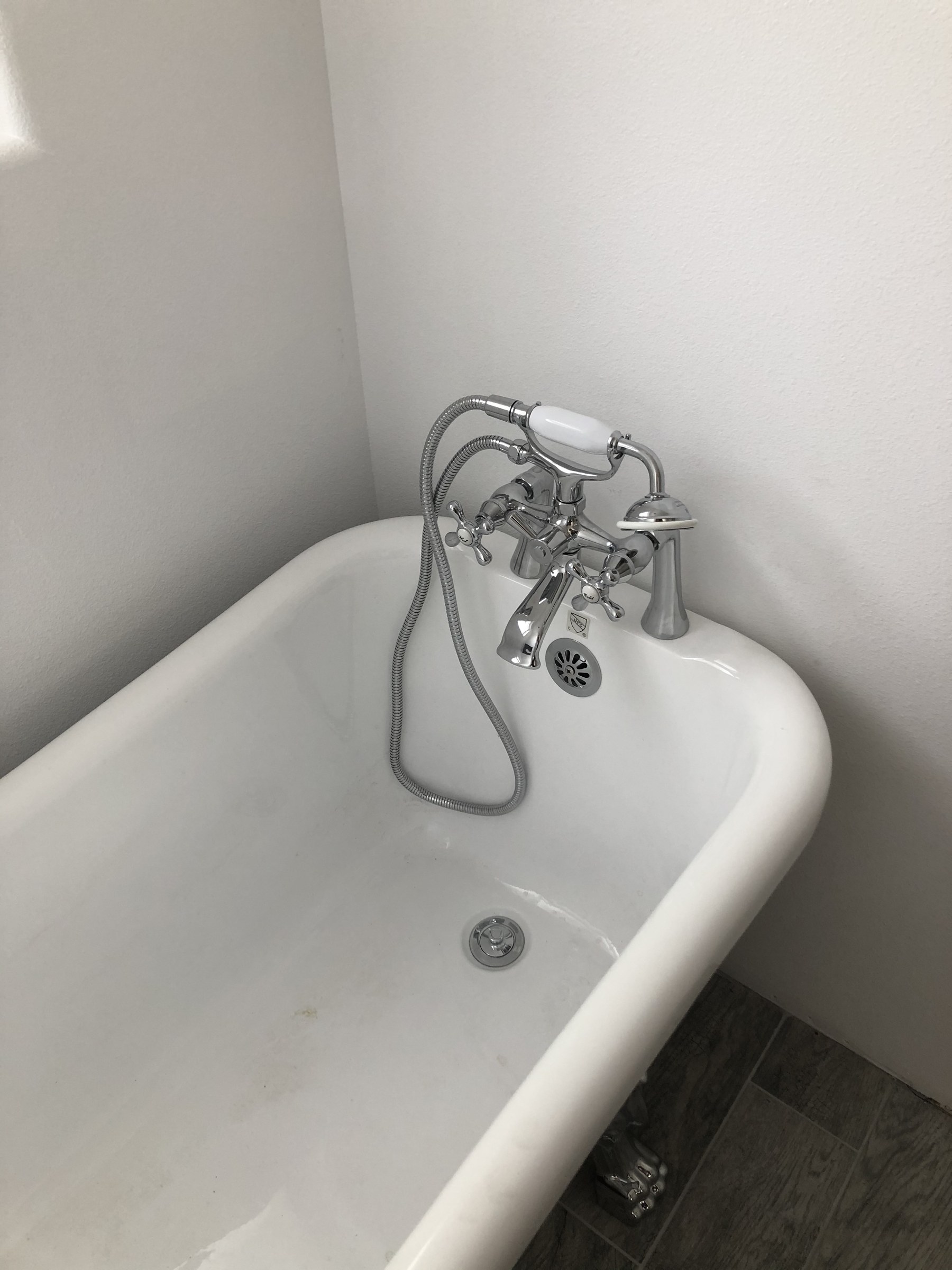 Clawfoot tub with chrome plumbing fixtures